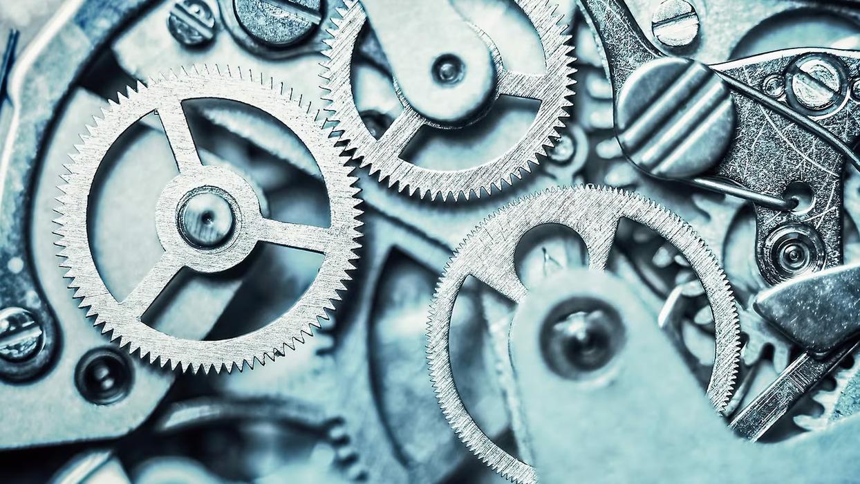 Ein Bild mit Zahnrädern die ineinander greifen.