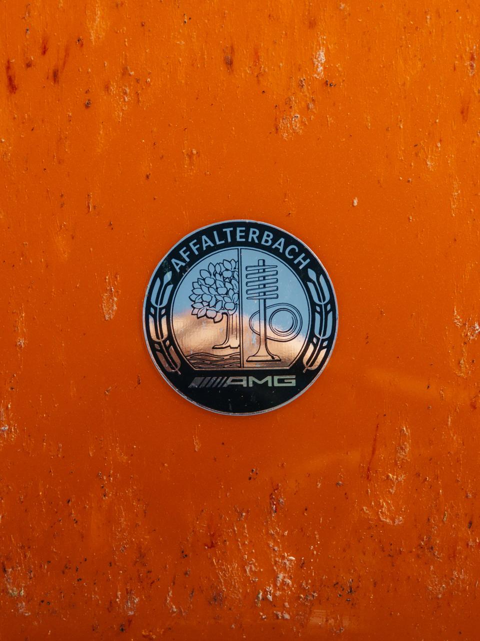 The AMG badge on orange background