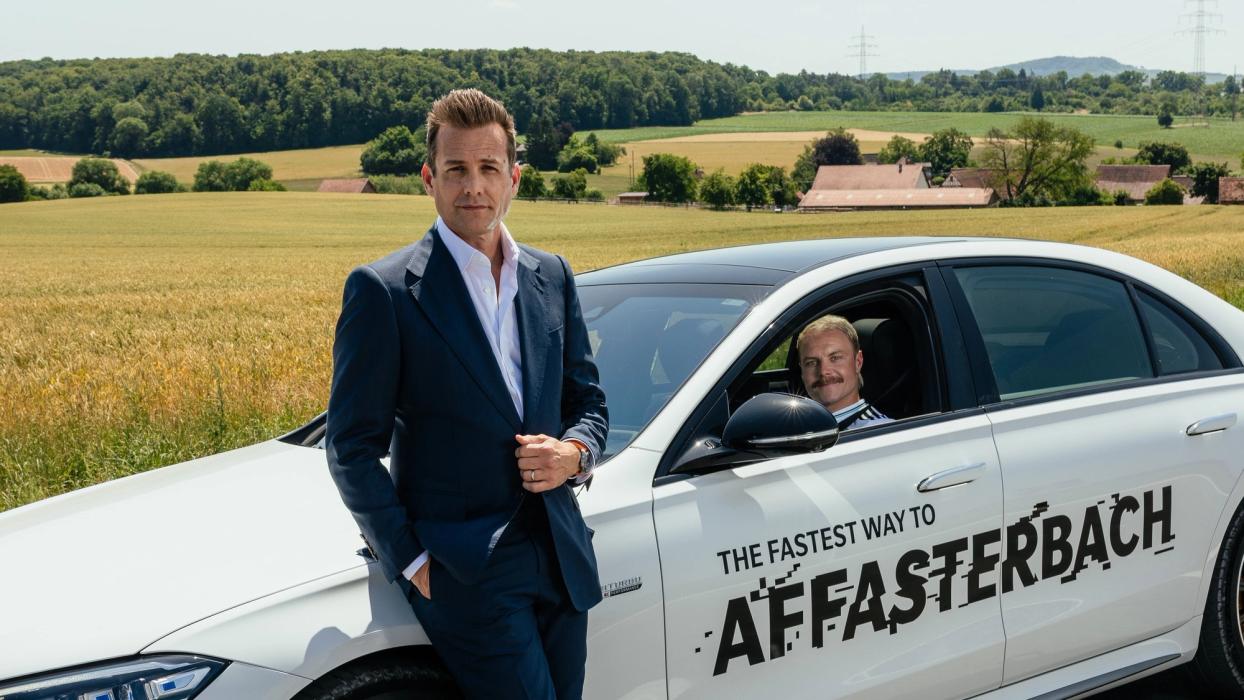 Gabriel Macht leans against a Mercedes-AMG