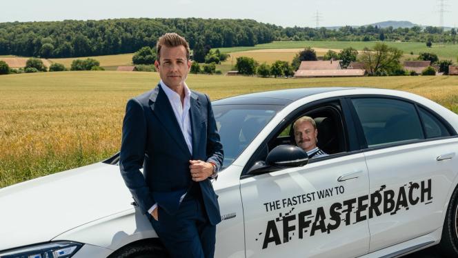 Gabriel Macht leans against a Mercedes-AMG