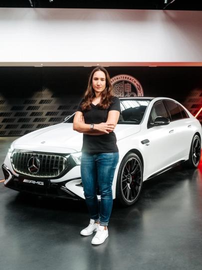 Produktmanagerin Sabine vor dem Mercedes-AMG E 53 Hybrid Limousine
