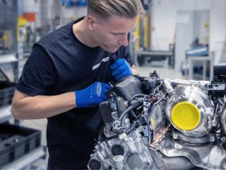AMG mechanic working on an engine