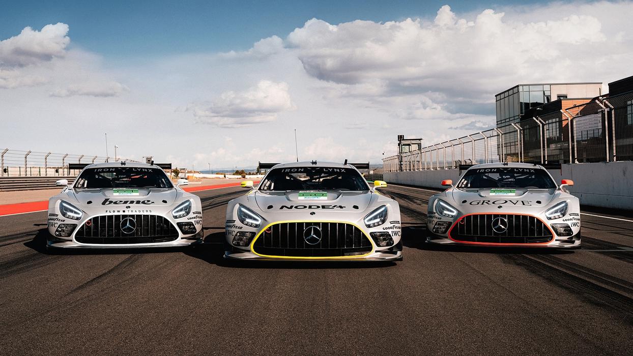 Three Mercedes-AMG GT racing cars parked next to each other on the race track
