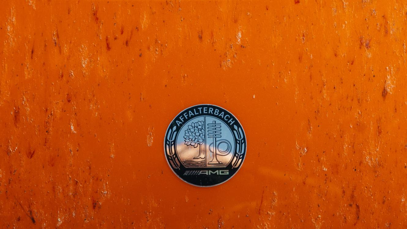 The AMG badge on orange background