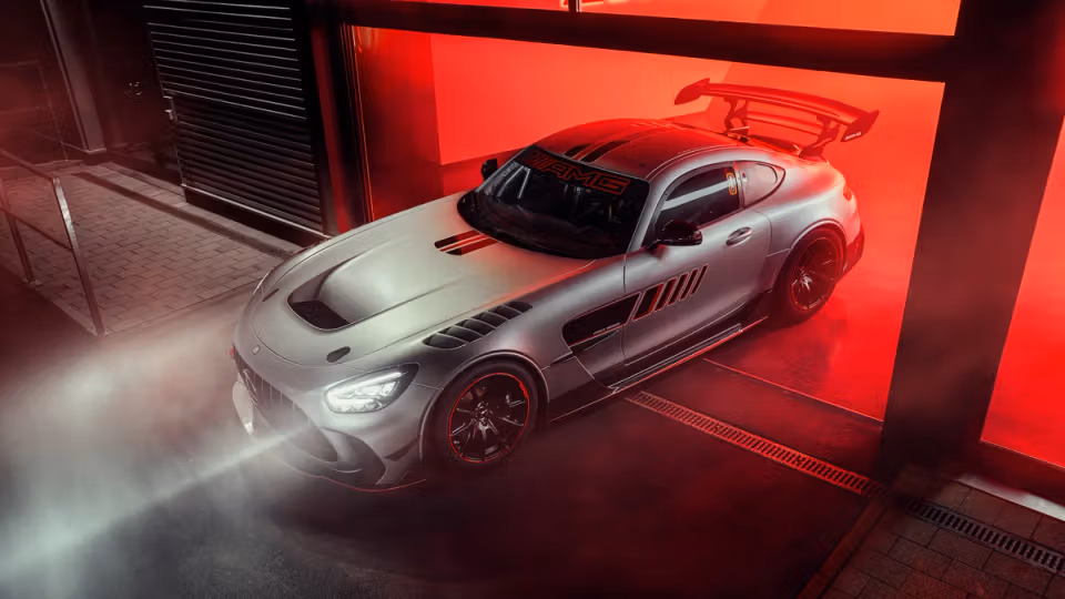 The Mercedes-AMG GT Track Series leaving a garage with shining headlights