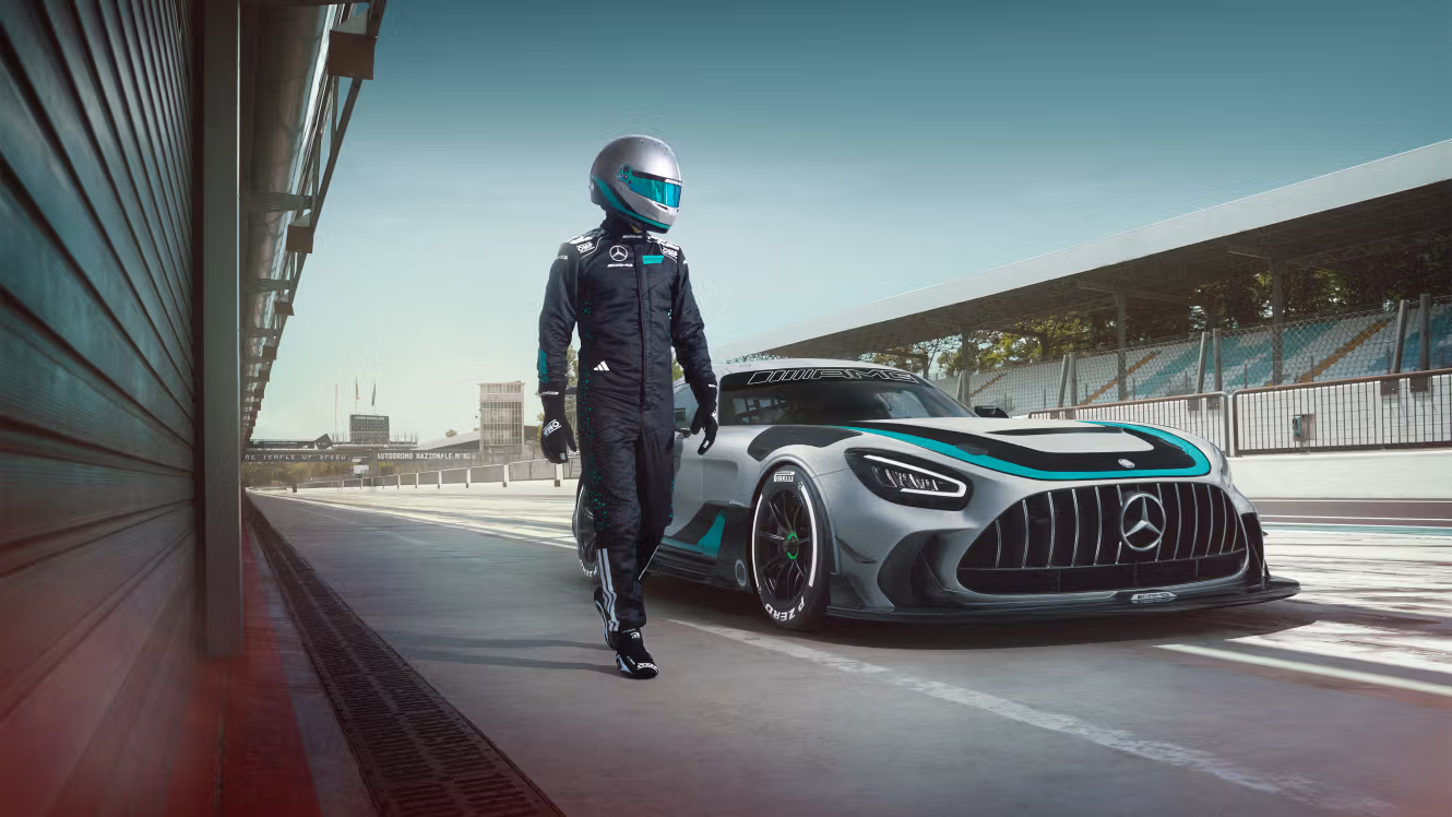 Racing driver runs alongside parked Mercedes-AMG GT2 Edition W16