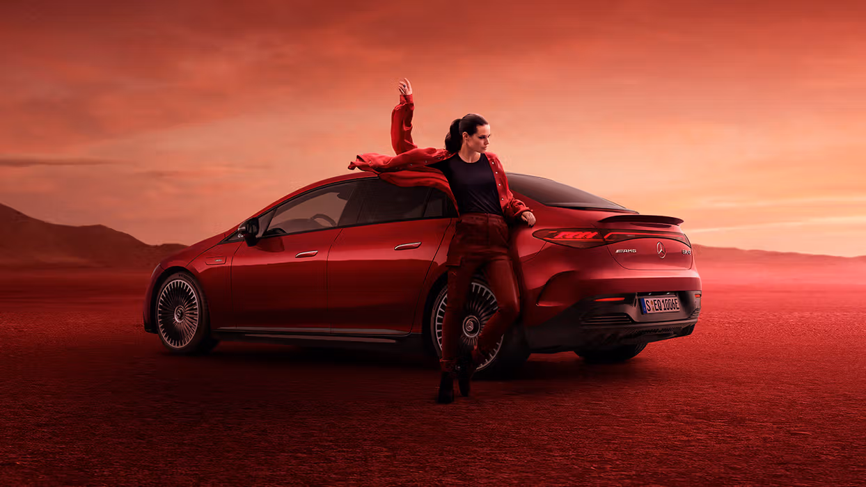A model posing in front of a Mercedes-AMG EQE 43 4MATIC.