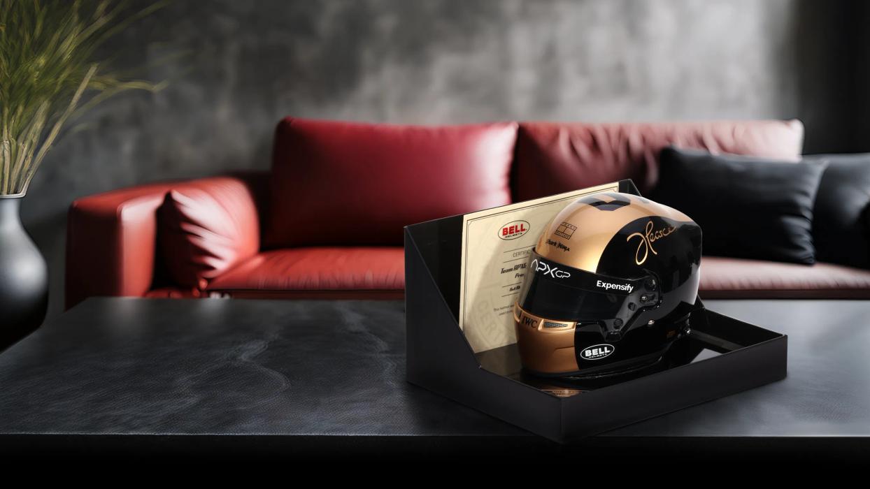 A Bell Mini helmet on a coffee table in front of a red leather sofa