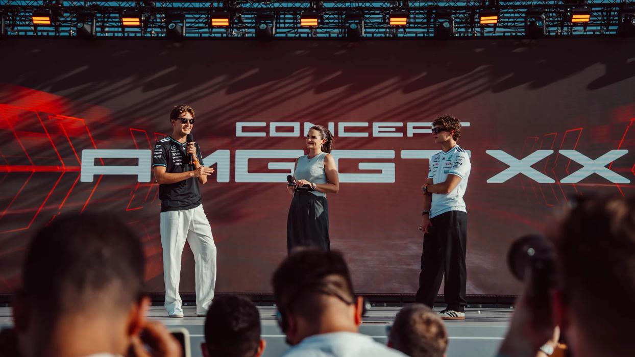 Kimi Antonelli and George Russel on stage in front of a CONCEPT AMG GT XX banner
