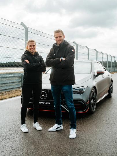 Maro and Viola pose in front of the Mercedes-AMG CLA 45 S 4MATIC + on a race track